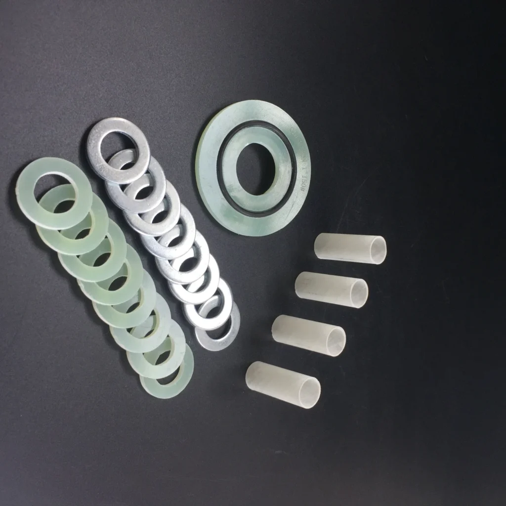 Insulating washers, metal backup washers and sleeves